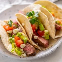 3 steak tacos with toppings