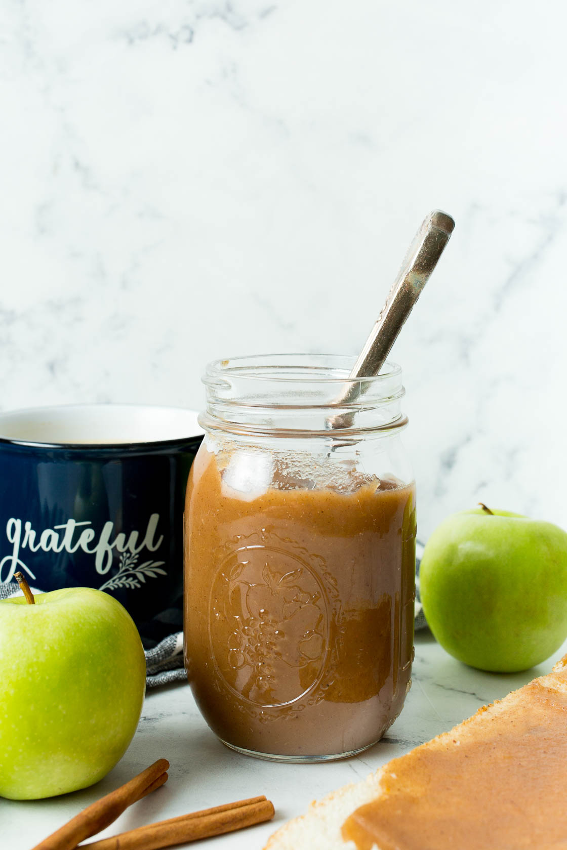 Apple Butter filled in jar with spoon sticking out