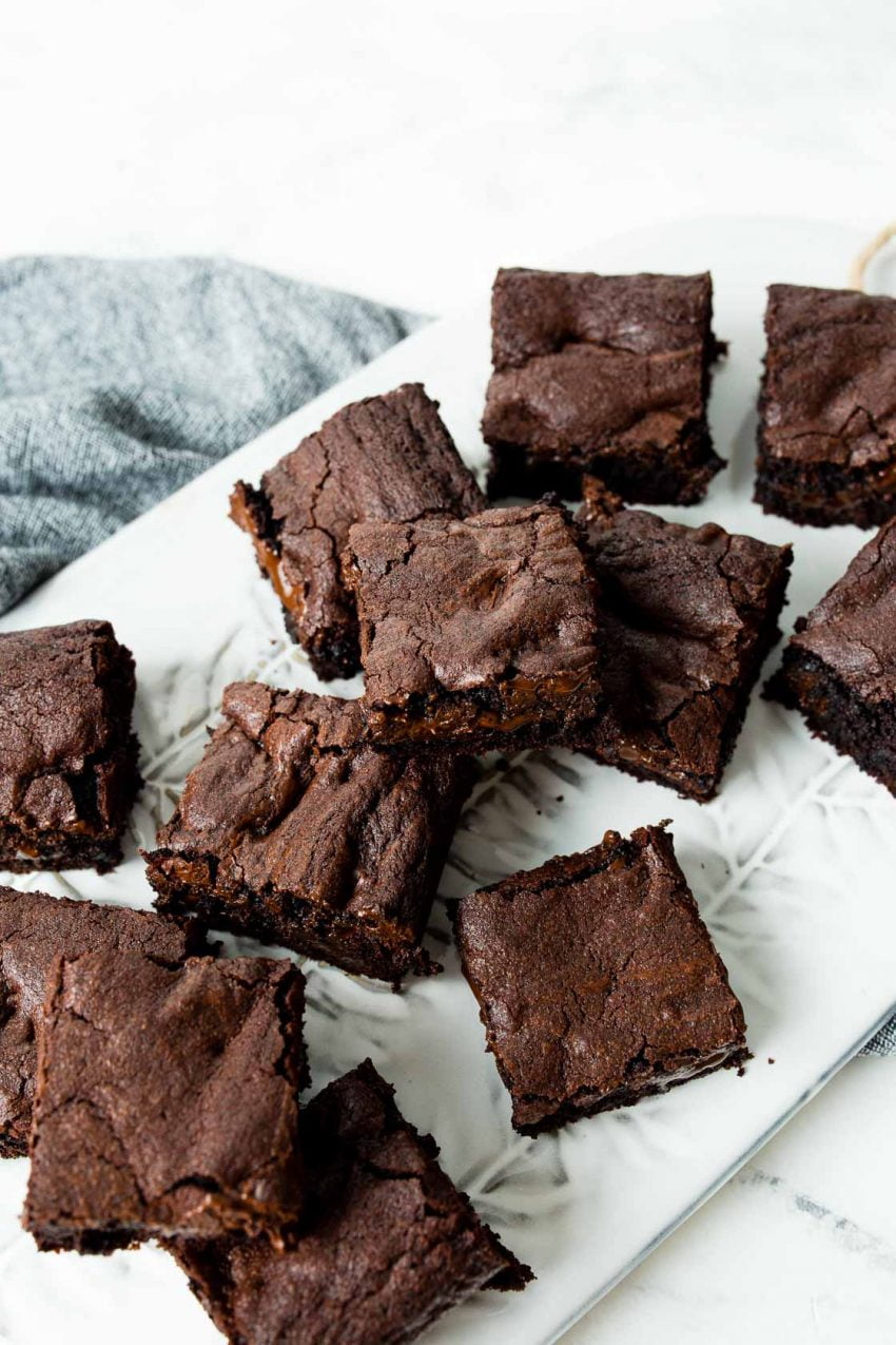 Image of: overhead view of crackling brownie tops, served on a white platter.