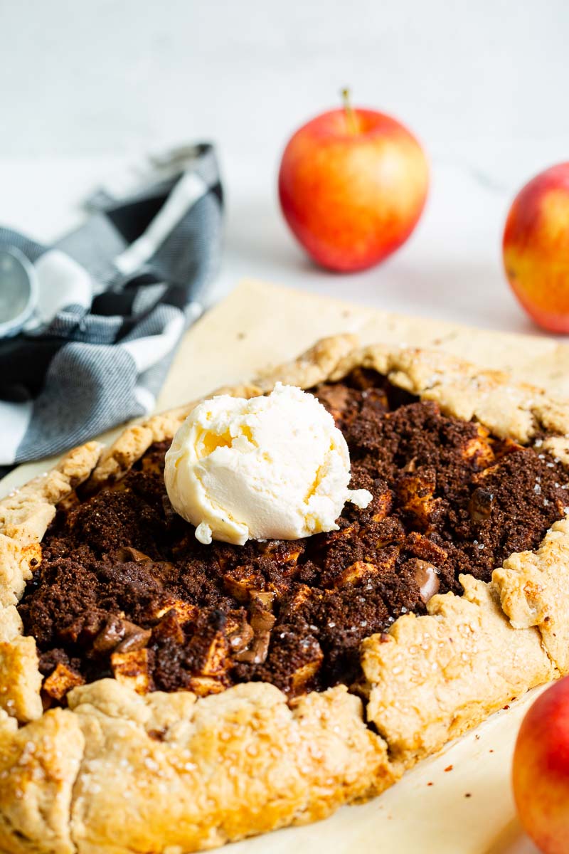 A finished apple galette is served with vanilla ice cream.