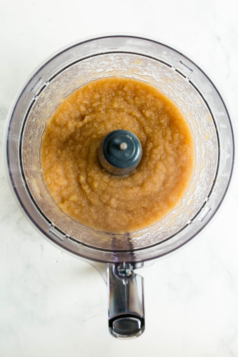 Overhead shot of slow cooker applesauce being smoothed out in food processor