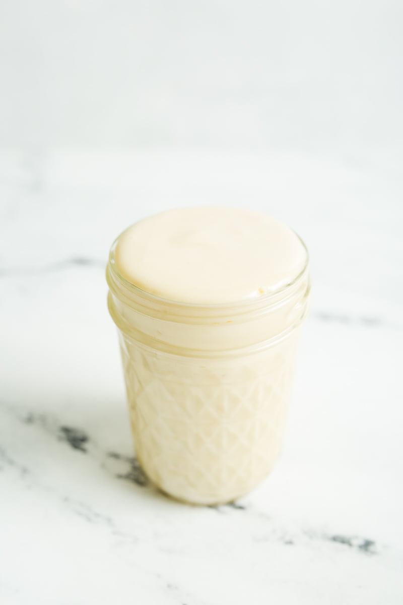 Small mason jar full of homemade sweetened condensed milk.